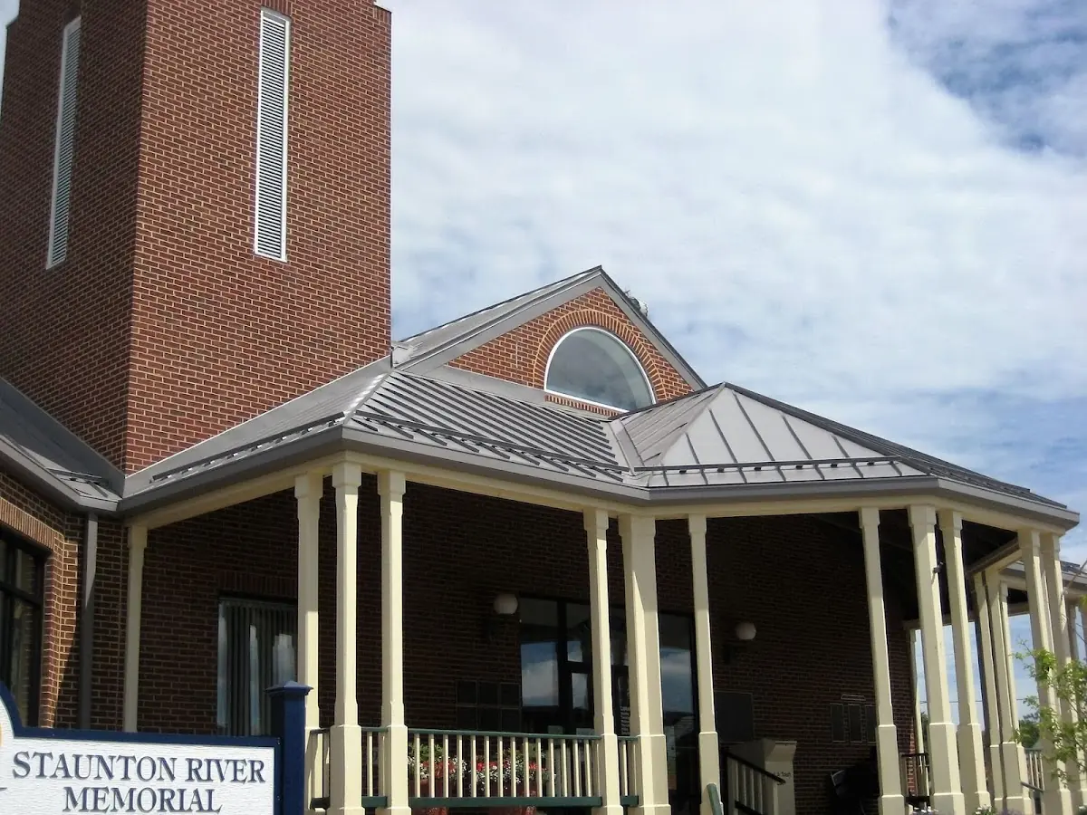 Skilled roofing craftsmen working on a residential roof in Keene